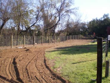 Fence Enclosure for Rescued Cats 850' of 6' high 2" x 4" fence with 5 gates. Project includes underground gopher wire along fence line to prevent coyo