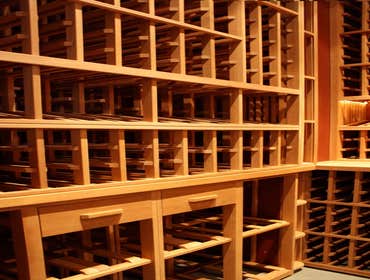 Project photos from Legacy Cellars Inc African mahogany wine cellar with curved upper wine racks.