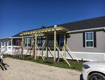 Custom pergolas, patios, decks On this project, we built a 12’ tall x 24’ long x 10’ wide pergola with a deck, railing, and lattice across the front to