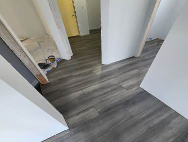 Photos by Flashbee Construction #1 Here we installed vinyl flooring throughout the house in one pc floor, with no trash holds or transitions between r