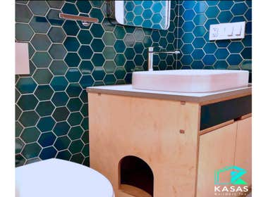 Bathroom remodel This remodel features a stylish, modern design with a special touch: a custom-built nook under the sink, perfect for your cat to relax