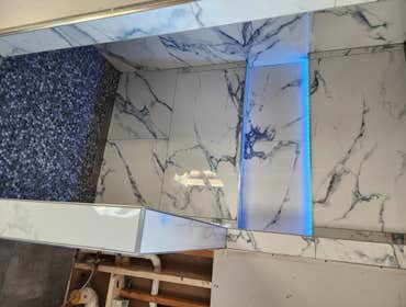 Custom hidden color changing led light shower with line drain. It's in a $500k addition