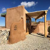 Tiny Workshop Built of rammed earth tires, masonry can and bottle work, and wood, we created a very small workshop for a couple of retired homeowners. 