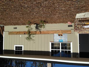 Ben Padgett. / Dixie Post Cards Installed foundation and walls with piers, then added sub floor.
Next installed exterior walls, dried in the entire ro