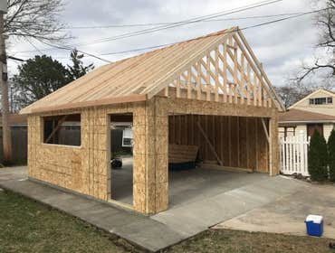 Photos by A-Windy City Garage Corporation #3 New garage construction with storage loft. Hardie siding and upgraded garage doors and windows.