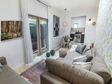 Sophisticated Attached ADU An unused garage space was transformed into a sophisticated, comfortable guesthouse. Space utilization is most valuable when