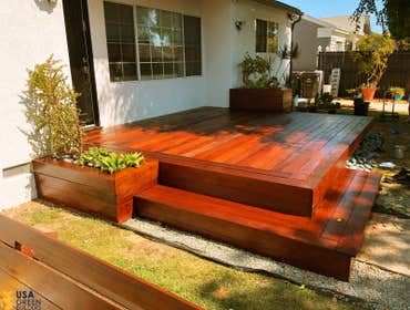 Dark Wood Decks Before and after pictures of a wood deck, and accented side plant holders.