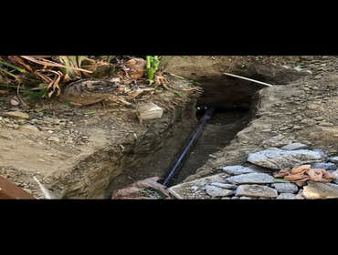 Before-install a new kitchen drain outside the house and connect it to the main city sewer