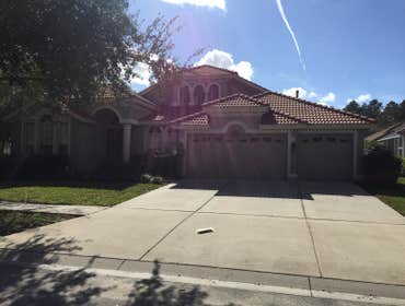 Photos from Popa Construction LLC Before & Afters of a soft wash roof cleaning and driveway and side walk cleaning.