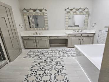 Photos by Complete Home Remodel & Renovation #3 This comprehensive bathroom remodel showcases a blend of modern elegance and functionality. Every aspec