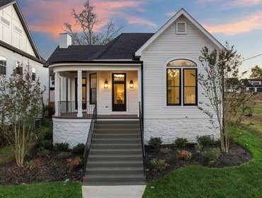 Restored historic facade with curved porch and new hardscape in 12 South, Nashville by CJMC Build.