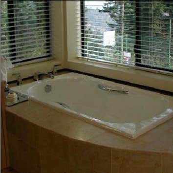 NW Penridge This beautiful spa-like contemporary bathroom features Italian limestone tile, including very unusual 18" x 18" floor tiles and mosaic deta