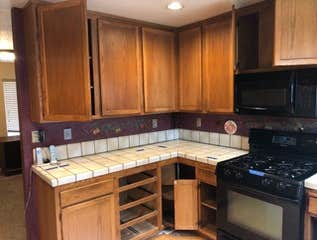 Kitchen Remove wall between kitchen and office to create open floor plan. Add new cabinets, flooring, appliances and lighting.