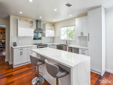 Kitchen remodel for Miss Sakai in Culver City! This beautiful white kitchen incorporates both quartz and mosaic pieces. The waterfall island adds an as