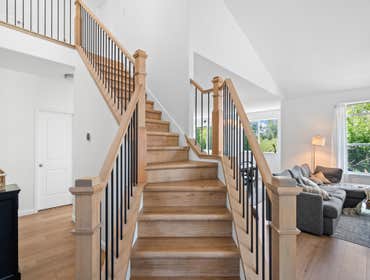 Photos by Vmr Custom LLC #1 Custom staircase and flooring installation featuring natural white oak treads, custom wood newel posts, and black metal bal