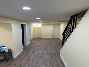 Photos by Your Expendable Services LLC #1 Basement remodeling project completed with new framework, walls placed and painted. New recess lights and LPV