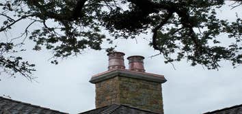 European Copper Pots on 5 chimneys. We designed, fabricated and installed custom copper flashing with 7 European Copper Pots for a luxury residence in 