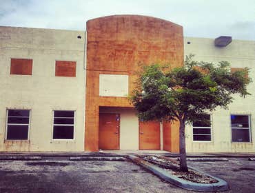 repainting warehouse in Hialeah Pressure washed, one coat of primer two coats of paint