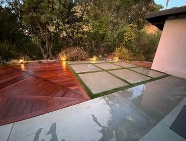 Photos by Ajp Landscape Inc #2 Elegant Outdoor Installation with Concrete, Turf, and Ipe Wood Decking
This custom outdoor project features a sleek gri