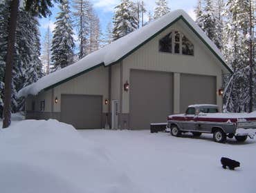 Log Home and Huge Shop This log home is set with 9 inch diameter turned cedar logs and framed dormer with cedar siding. It has a 12 by 24 log carport a