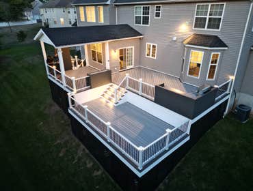 Photos by F&d Construction LLC #1 New composite deck, 2 section with electrical ligth post, light stair, heater, fan, kitchen outdoor...