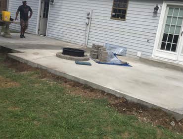Photos by From the Ground Up #2 Removed deck and brick pavers and installed a concrete patio slab with a fir pit.