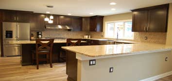 Kitchen remodel To expand this kitchen, the load bearing kitchen/dining room partition wall was removed. A steel beam was installed in the ceiling to c