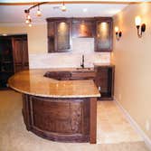 Basement Finishing Project Basement Finish in Overland Park featuring a radius wet bar.
