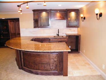 Basement Finishing Project Basement Finish in Overland Park featuring a radius wet bar.