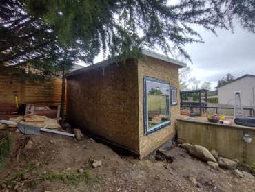 Photos by Stewart & Son Gate & Fence LLC #1 Tiny House with pergola. Small house 17' by 12' small bathroom with pocket door, and small sink with water 