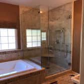 Photos by Griffin Tile & Marble Co #1 Master bath remodel. Remove PVC shower insert , remove separating wall , install new tile shower matching the til