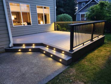 Modern PVC Deck with Integrated LED Stair Lighting This premium low-maintenance deck was built using TimberTech Advanced PVC decking in Coastline with 