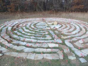 Labyrinth A labyrinth is an ancient symbol that relates to wholeness. It combines the imagery of the circle and the spiral into a meandering but purpos