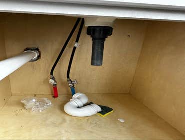 Photos by Des in the Cut Construction Company #1 We replaced a plastic, double-sink drain with pvc pipes, two P-traps and installed a vent so the water