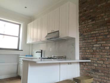 Upper West Side Our work for this project included full gut renovation with exposed brick wall, Calacatta countertop, and glass shower. Bathroom with c