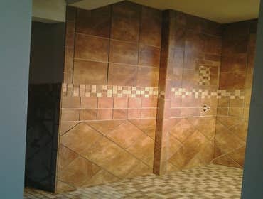 Nuroom Remodeling walk-in shower Huge 9' x 5' walk-in shower project with complex tile layout and custom shower base.