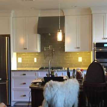 cabinet and backsplash under cabinet lighting Custom cabinetry with crown moldings. Installed water spout above stove and tiled back splash. Installed