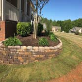 Mulch and wall installation Before and after pic