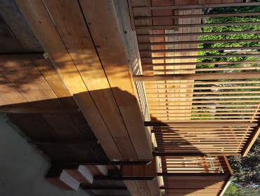 Broadway Terrace Back Deck Retaining wall with steps to a 28'x14' Redwood deck with 36' of bench.