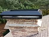 Chimney cap on stone chimney