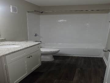 Photos by Combined Construction Services, Inc #1 Interior multi-family renovation including cabinets, countertops, flooring, paint, trim, and appliance