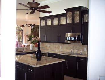 The Tricks Kitchen This beautiful kitchen was designed and custom manufactured in Birch plywood ( natural grain ) and Shaker thermofoil doors in Espres