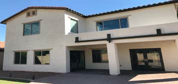 Photos by E&S Painting LLC #2 Repaired stucco around new windows, repaint, change color entire house with black and white colors.