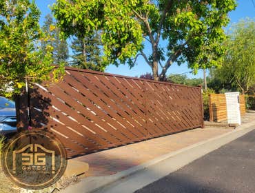 Custom Laser Cut Dual Swing Automatic Gate Installation in Orinda, California Custom laser cut dual swing automatic gate installation completed in Orin
