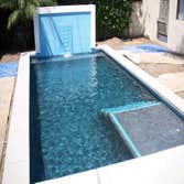 Photo(s) from CUSTOM DERIAN POOLS Infinity Pools, Hillside Pools, Landscaping, BBQs, Outdoor Fireplaces, Shade structures, Pergolas, Landscaping, Mason