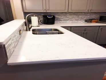 Manassas Project The cabinets are J&K K3 Greige Maple and the counter-tops are MSI Carrara Marmi quartz.