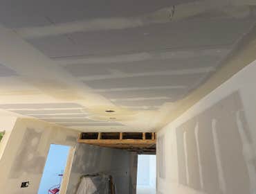 Photos by Interior Art Drywall Inc #1 Hang the walls on ceiling and walls . I just let the open on ceiling where plumbers were pending to fix the pipes