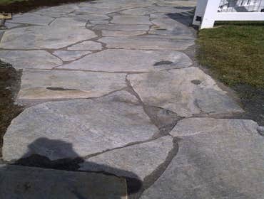 Paver Patio and Walkway This is a a combination of some of our work. Landscaping box and Veneer retaining wall, walkway and flagstone patio.
