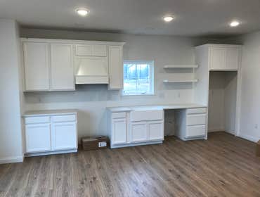A Simple, Elegant, and Affordable Kitchen This kitchen is designed to be stylish, functional, and budget-friendly. Shaker-style cabinets in a soft neut