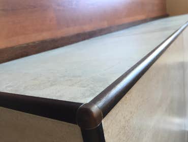 The Buskin A mid century modern fireplace with a custom oak mantel, large 18x18 and 12x24 porcelain tile from Pacific Tile, urethane grout and oil rubb